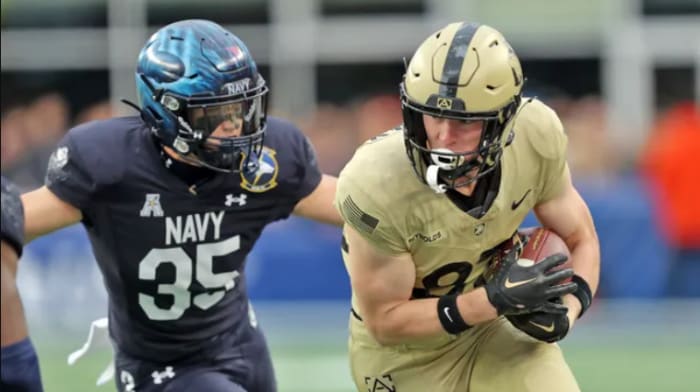 Army's Casey Reynolds (R) flees from Navy's Kush'i Abraham during Saturday's game